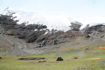 Fototapeta na wymiar View of the Karola glacier near the highway with the tent, Tibet, China