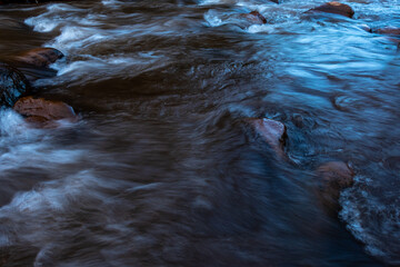 Stream of flowing river water abstract blurred motion the evening light at Sapun village, Boklua, Nan Province, Thailand