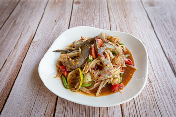 Papaya salad with shrimp in white on black background. Thai food delicious and popular