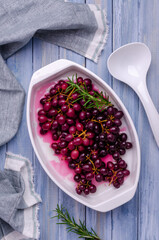 Baked bunches of dark grapes with rosemary