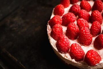 Fresh cheesecake with raspberries on the rustic background. Selective focus. Shallow depth of field.