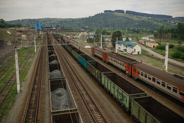 Top view of a railway marshalling yard with railroad cars. Coal industry. Commodity train with coal. Coal wagons, coal transportation in freight wagons. Formation of a coal train in a freight depot. 