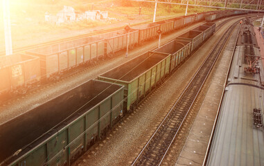 Naklejka premium Top view of a railway marshalling yard with railroad cars. Coal industry. Commodity train with coal. Coal wagons, coal transportation in freight wagons. Formation of a coal train in a freight depot. 
