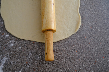 Rolling pin with dough to prepare Nigerian Chin Chin