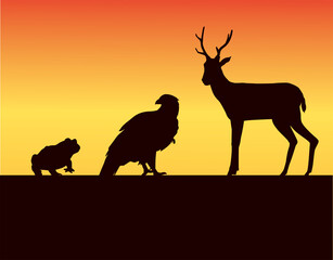 Fototapeta na wymiar group of wild animals silhouettes in the sunset landscape