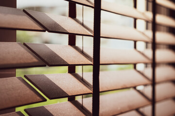 Closeup of a wooden window venetian blinds in the bedroom full of tiny pieces of particle dust...