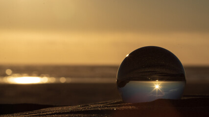 Fototapeta na wymiar Beach sunset with glass ball