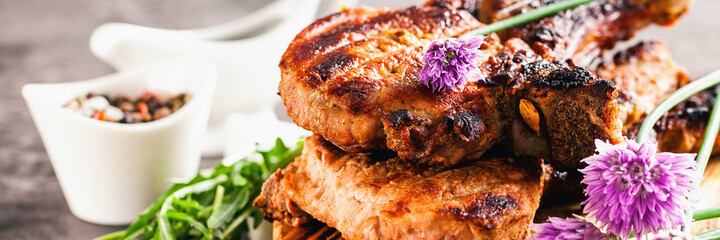Grilled ribeye beef steak with onions, herbs and spices. Selective focus