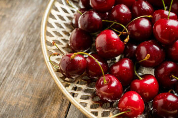Freshly harvested cherries on vintage metal plate. Selective focus. Shallow depth of field. 