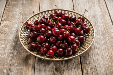 Freshly harvested cherries on vintage metal plate. Selective focus. Shallow depth of field. 