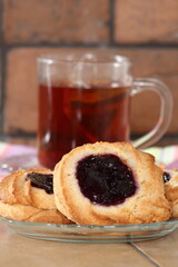 Marzipan cookies with jam and cup of tea