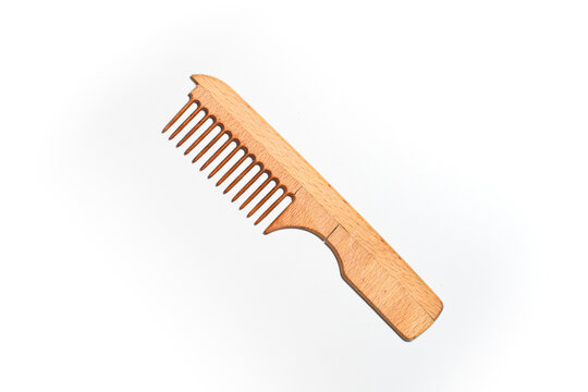 Wooden comb with handle on a white background