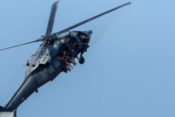 Military combat and war with helicopter flying into the chaos and destruction. Soldiers suspend...