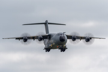 Large four engined military cargo airplane on approach to land.