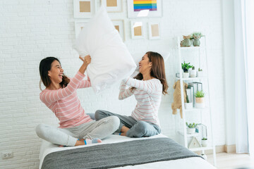 Lesbian couple homosexual happiness lifestyle on bed. Two pretty girlfriend talk, hug and laugh together relation fall in love. LGBTQ relation lifestyle concept.