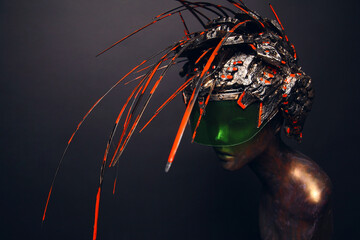 Bronze head of mannequin in decorated bronze helmet, dark studio background
