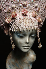 Head of mannequin in creative pink kokoshnick with jewels and pearls