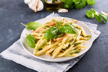 Traditional pasta trofie south of Italy with pesto and basil. Homemade meal for lunch. Healthy, tasty, meat-free food. Italian Cuisine. High quality photo