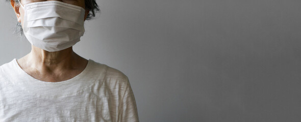 Close-up of the woman of the elderly person wearing a mask. Illness, pneumonia, cold, infectious...