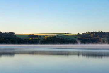 Summer landscape with pond in morning light