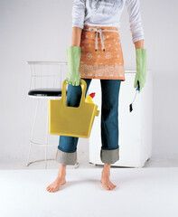 young woman holding bags and clean house