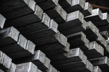 Steel billets in the warehouse of metallurgical factory. Hot ingot in a steel plant.