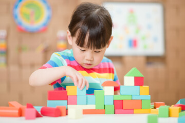  young girl playing creative toy blocks for homeschooling