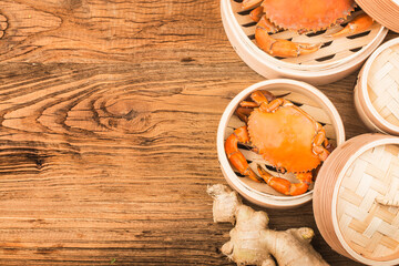 Cooked crab on steamer and Wooden planks background
