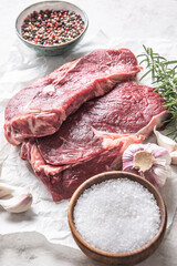 Two Rib eye steak salt spices rosemary and garlic top of view