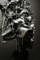 Head of mannequin in creative metal kokoshnick, dark studio background