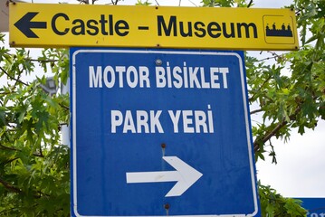 Pointer to the castle and museum and the translation of Blue-white sign: 