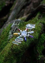 Crystals and Quartz Pyramid on moss nature background. Magic Rock for Crystal Ritual, Witchcraft. Seven Direction Reiki Stone for Energy Healing Meditation