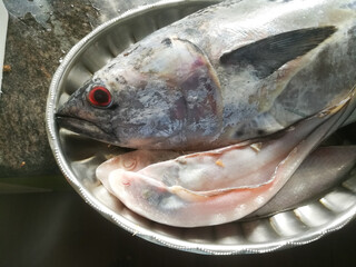 Raw Sea fish with red eyes in a steel plate kerala specials.
