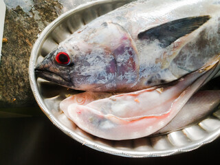 Raw Sea fish with red eyes in a steel plate kerala specials