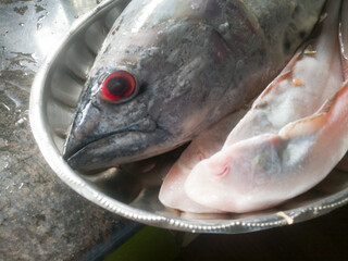 Raw Sea fish with red eyes in a steel plate kerala specials.