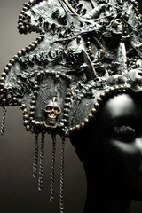 Head of mannequin in creative metal kokoshnick, dark studio background
