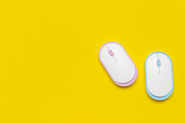 Modern computer mouse devices on color background