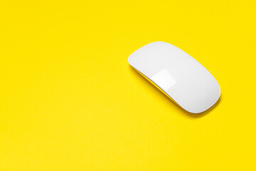 Modern computer mouse on color background
