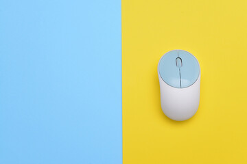 Modern computer mouse on color background
