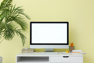 Modern PC monitor with blank screen on table