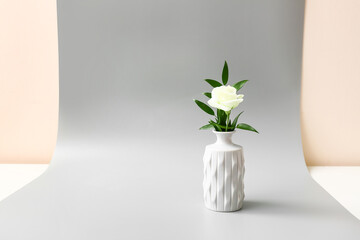 Beautiful vase with flower on grey background