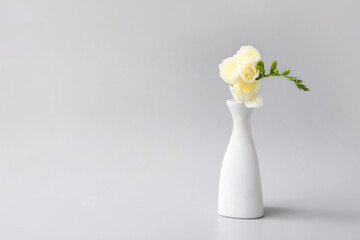 Beautiful vase with flowers on grey background