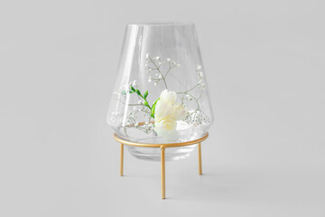 Beautiful vase with flowers on grey background