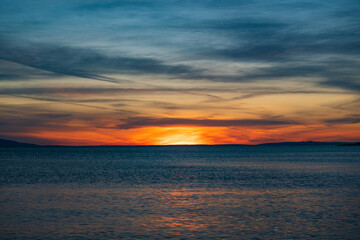 Fototapeta na wymiar Croatia, island of Pag, beautiful dramatic sunset over Adriatic sea horizon, red sky