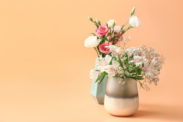 Beautiful vases with flowers on color background