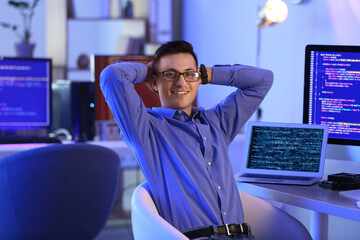 Portrait of male programmer in office at night