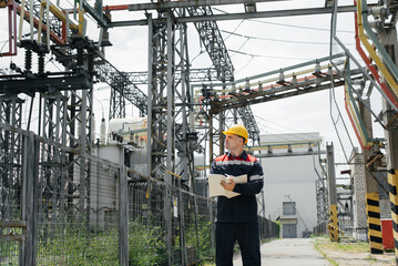 The energy engineer inspects the equipment of the substation. Power engineering. Industry.
