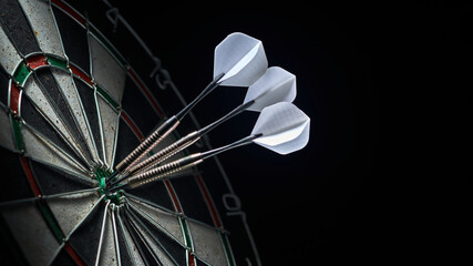 3 darts in the center of the dartboard - 369199222
