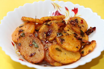 Aloo Katli or Potato Katli is an excellent and tasty asian dish, slices of fried potatoes, sauces and herbs, snack or starter 