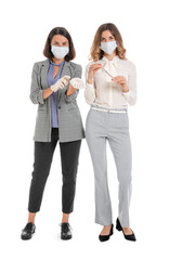 Fototapeta premium Female makeup artists wearing medical masks on white background. Coronavirus epidemic